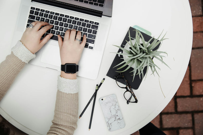 A tidy desk with laptop and plant, cleared for focus