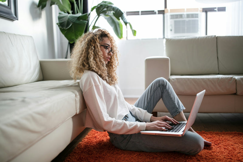 Woman working quietly from the living room floor